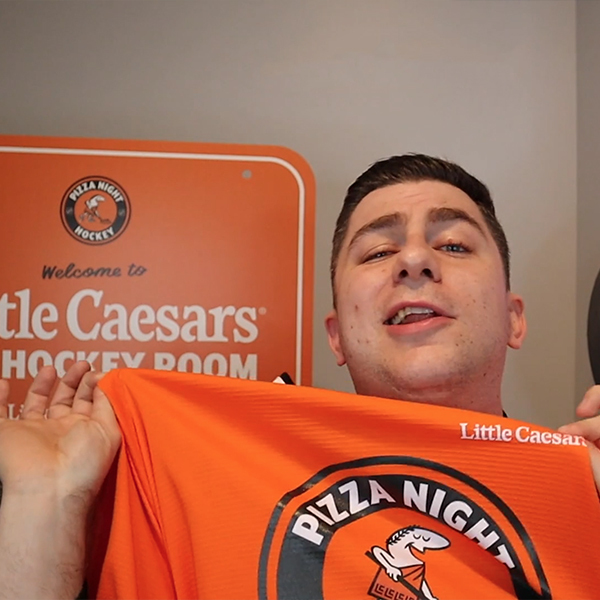 The winner of the contest posing with a Little Caesar's t-shirt