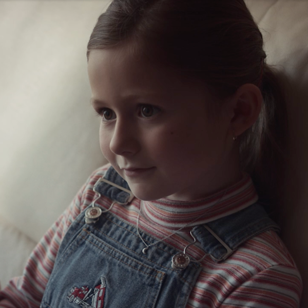 A little girl sitting on a couch